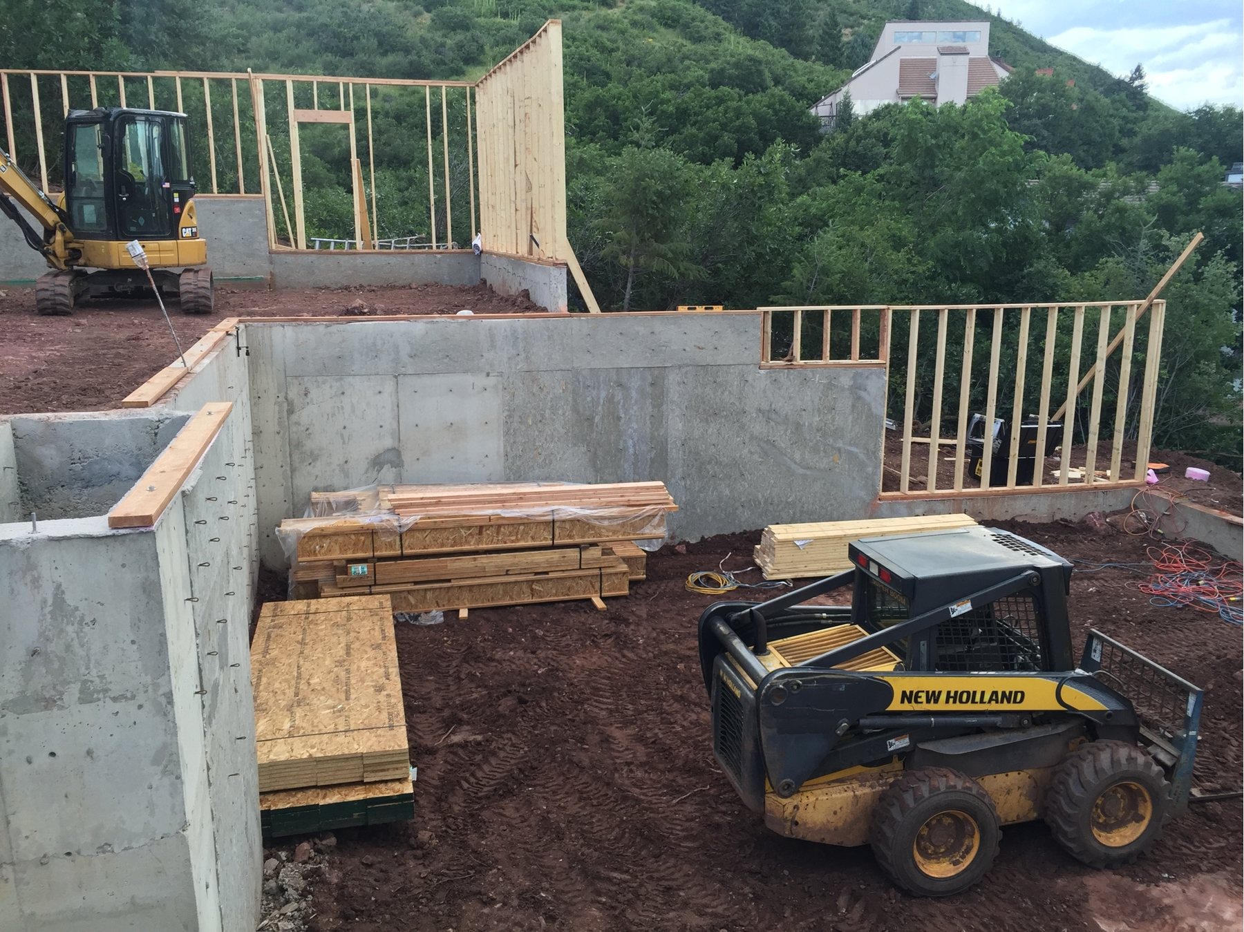 Foundation complete with the first framed walls standing on a finished deck
