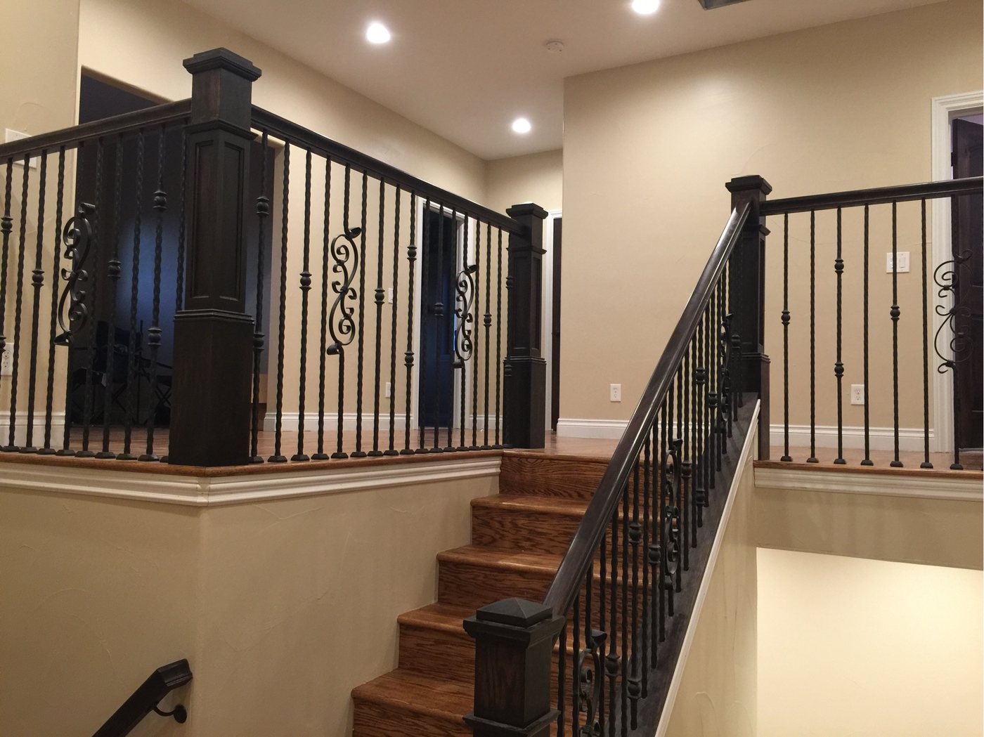 The completed stair with finished newels, iron balusters and hardwood treads